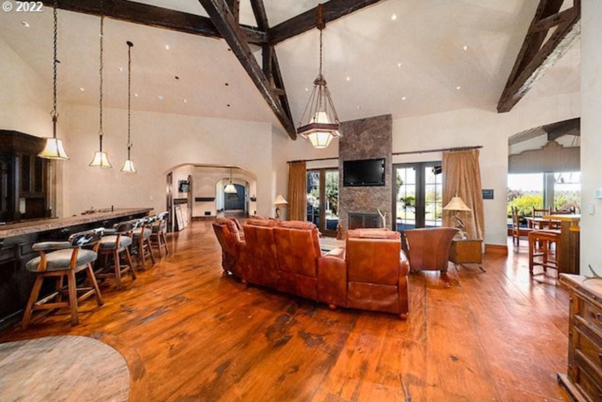 Living room with custom lighting, couches and a fireplace.