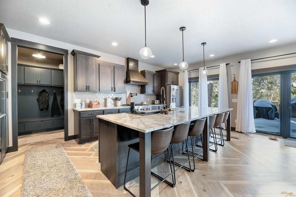 Kitchen with ample cabinetry, backsplash and center island.