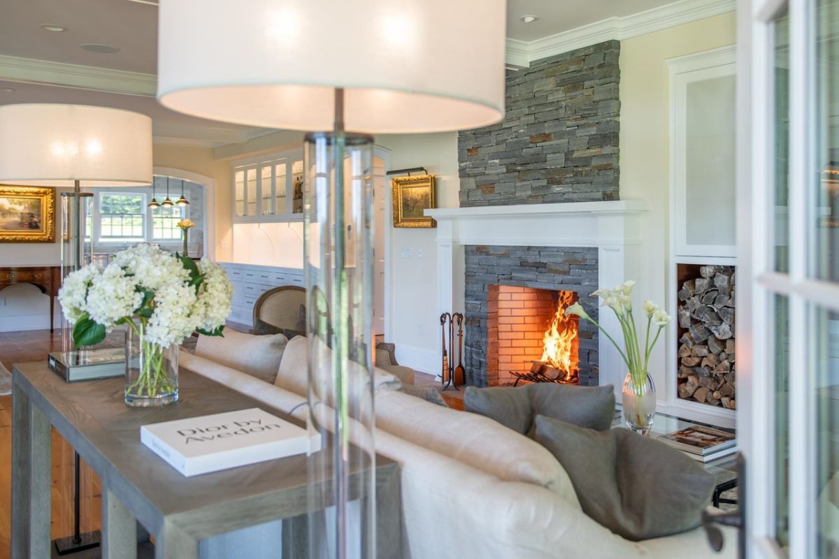 Living room with a couch, lamps and a fireplace.