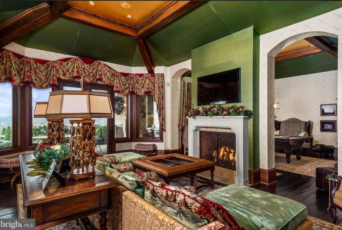 Living room with couches, a chandelier and a fireplace.
