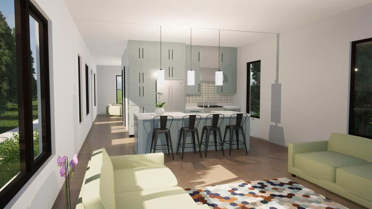 Living room and kitchen with facing sectionals, a multicolored rug, and a center island lined with four bar stools.