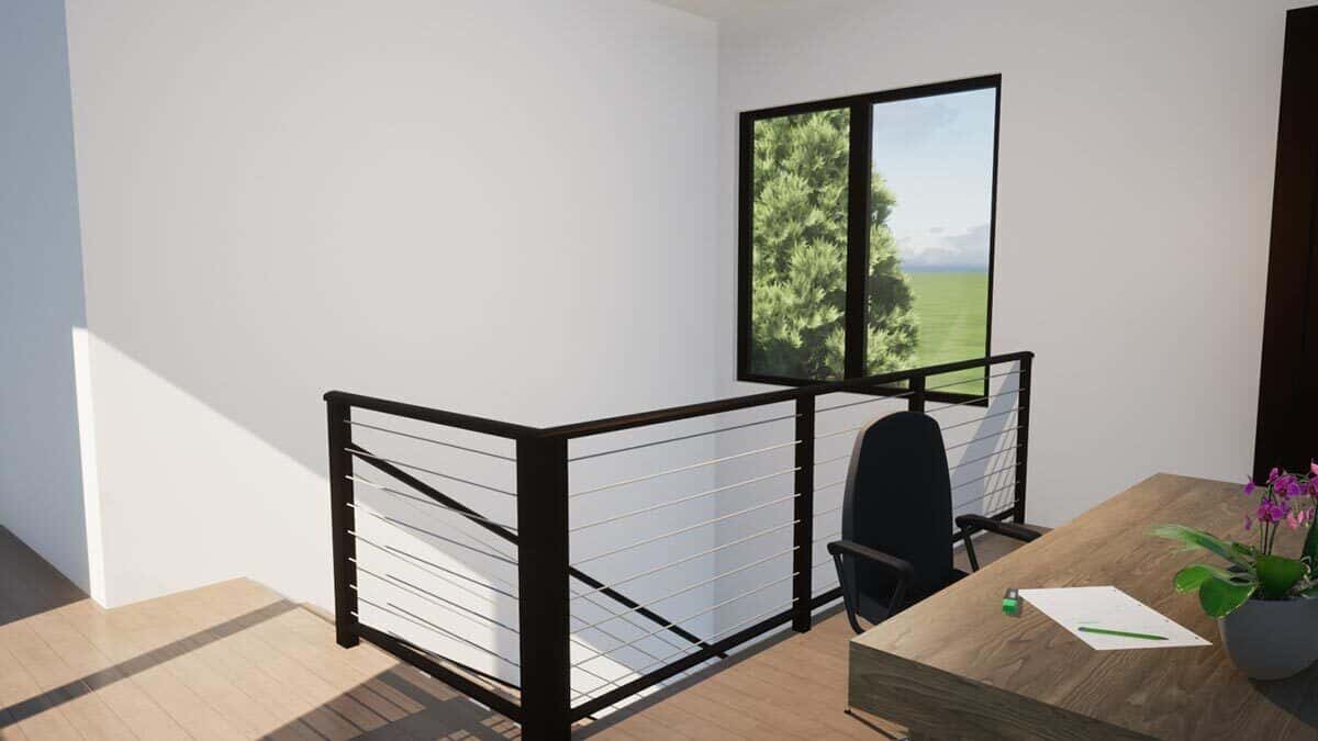 Loft with wrought iron railings and a wooden desk that blends in with the hardwood floor.