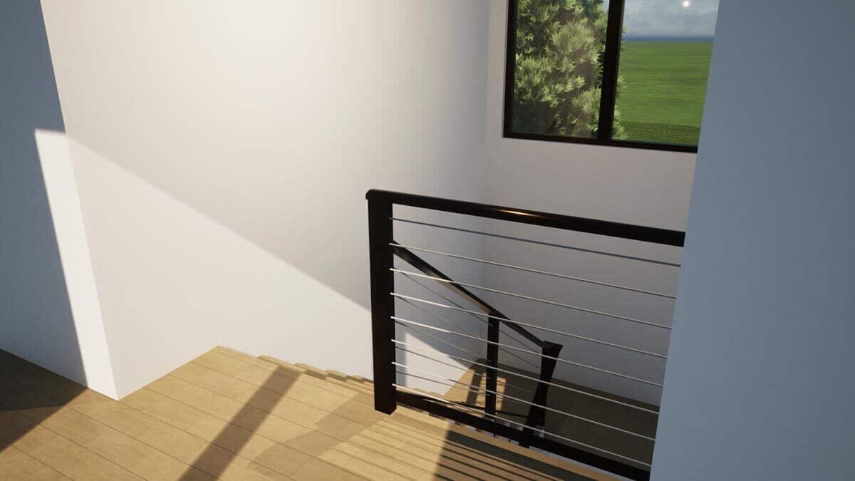 Stairs with metal railings leading to the upstairs bedrooms.