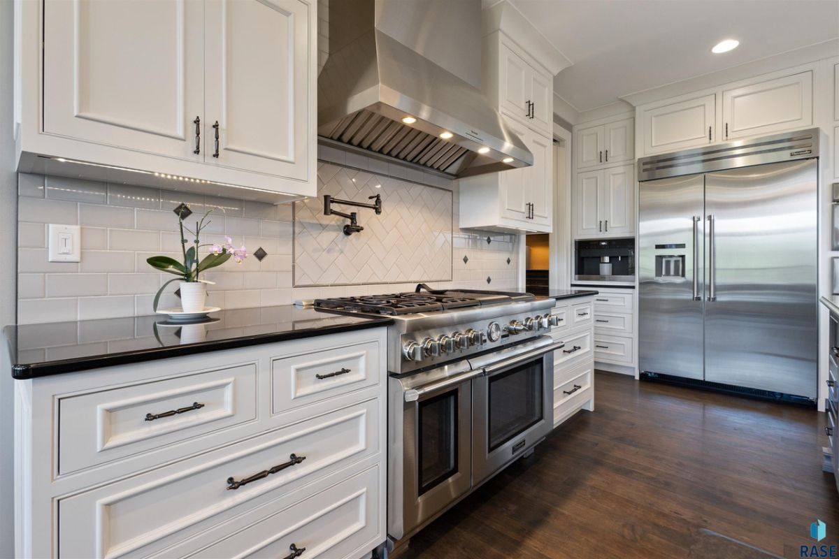 Kitchen with a gas range, double ovens and custom cabinetry.