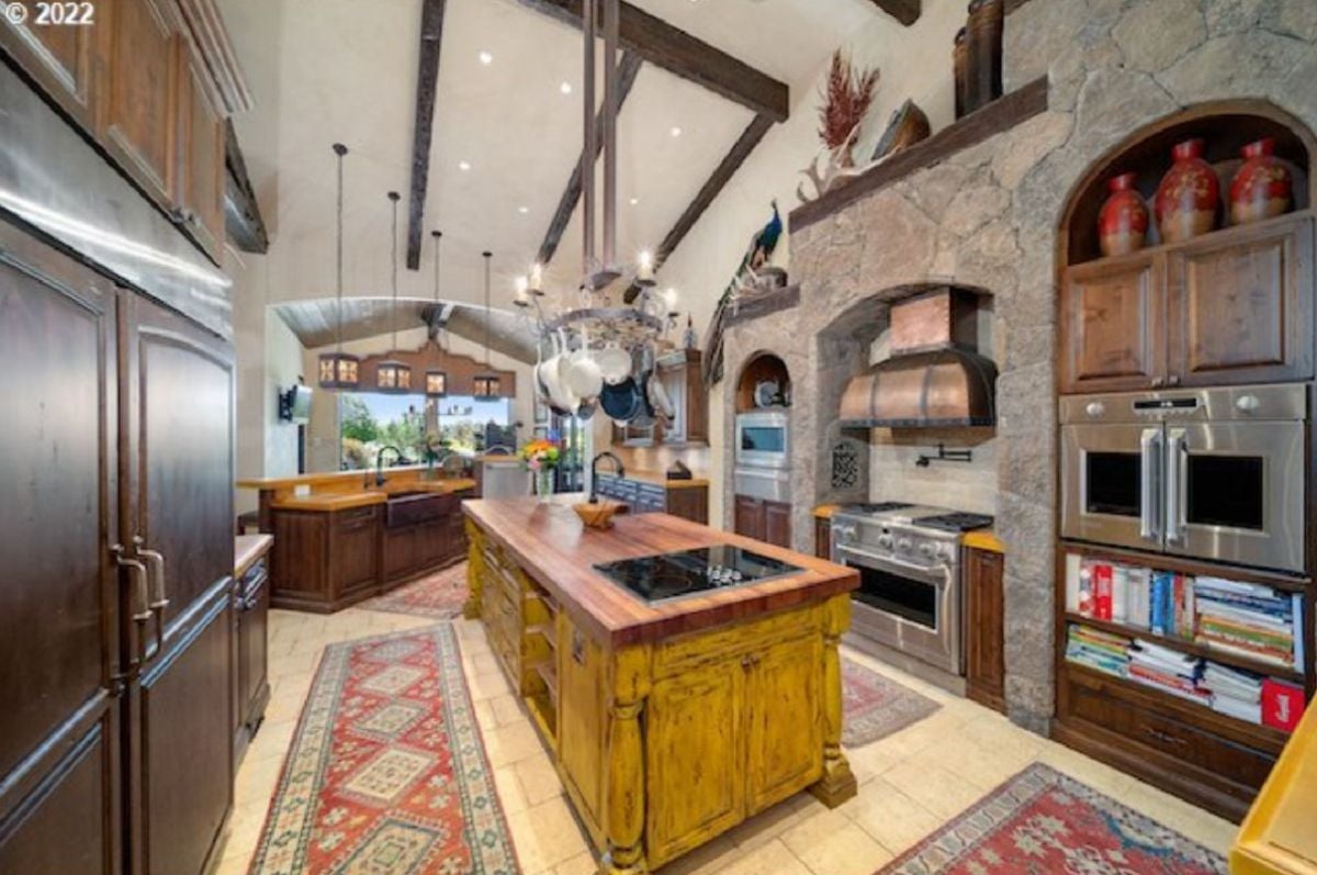 Kitchen with a large island and a large stove.