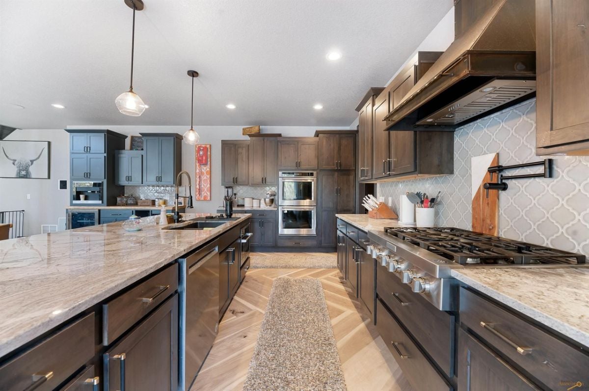 Kitchen with custom lighting and and stainless appliances.