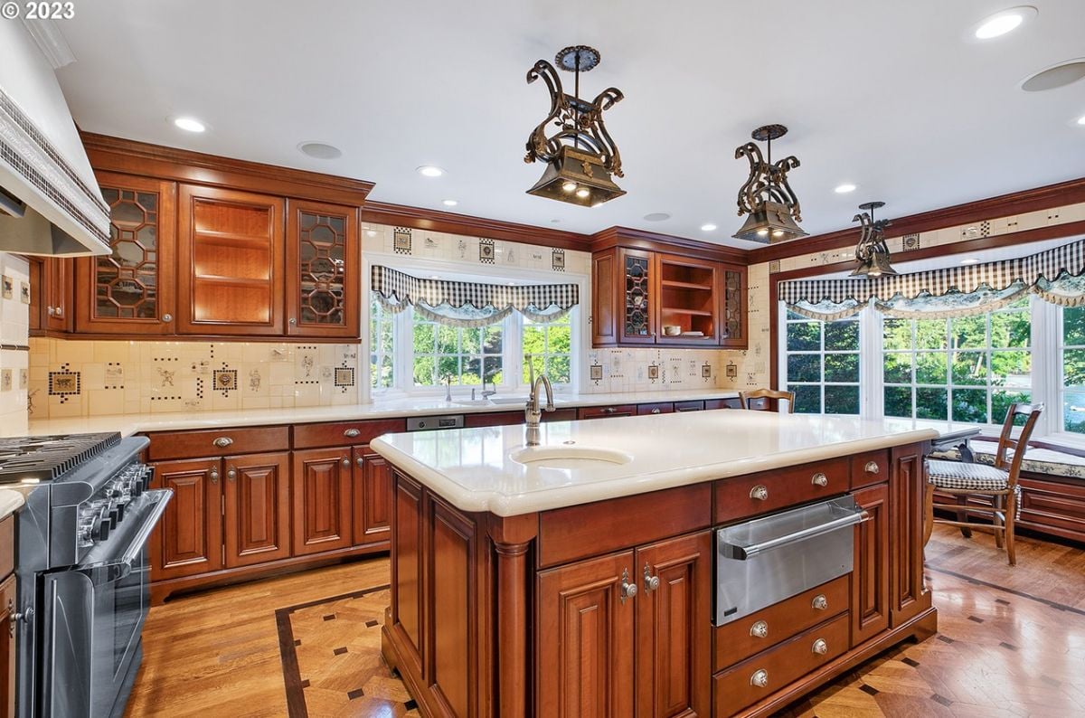 Kitchen with wood flooring, custom lighting and custom cabinetry. 