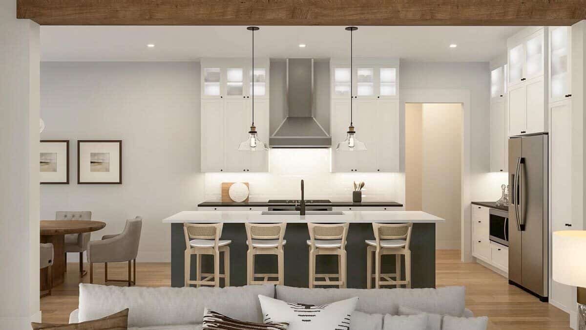 Kitchen with custom cabinetry, stainless steel appliances, and a breakfast island with four seating.