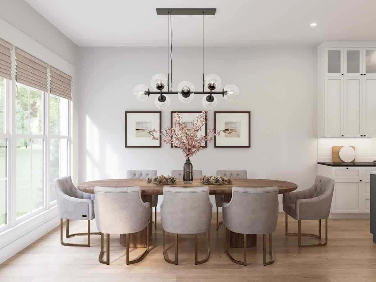 Dining room with an oval dining set topped with a linear chandelier.