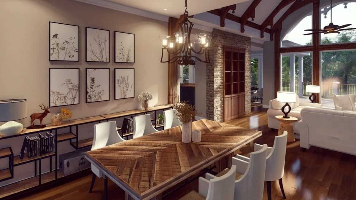 The dining room includes an elongated metal table adorned with a gallery wall.