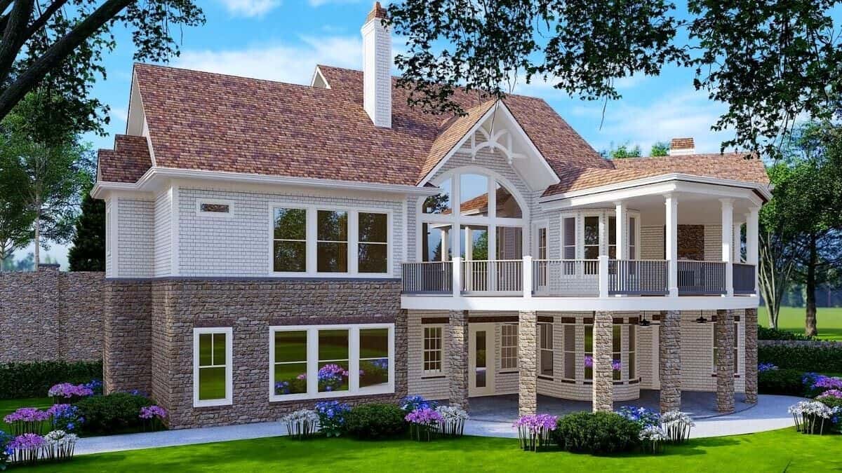 Rear rendering with covered porches and an open deck supported by stone pillars.