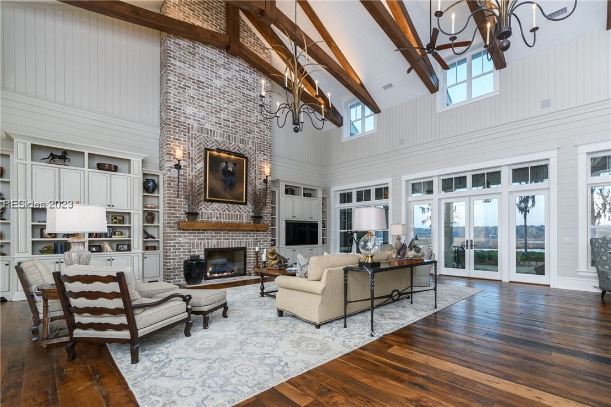 Living room with a fireplace, couches, and Cathedral ceiling.