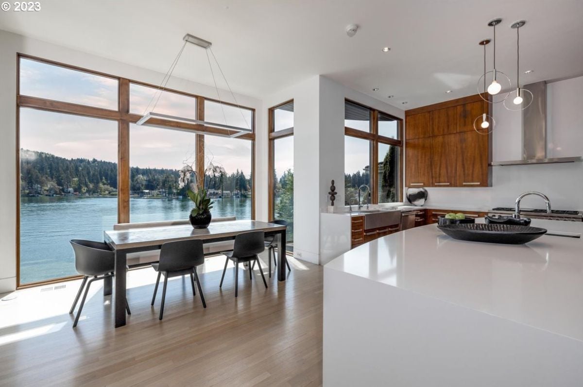 Breakfast area with large glass windows overlooking the lake.