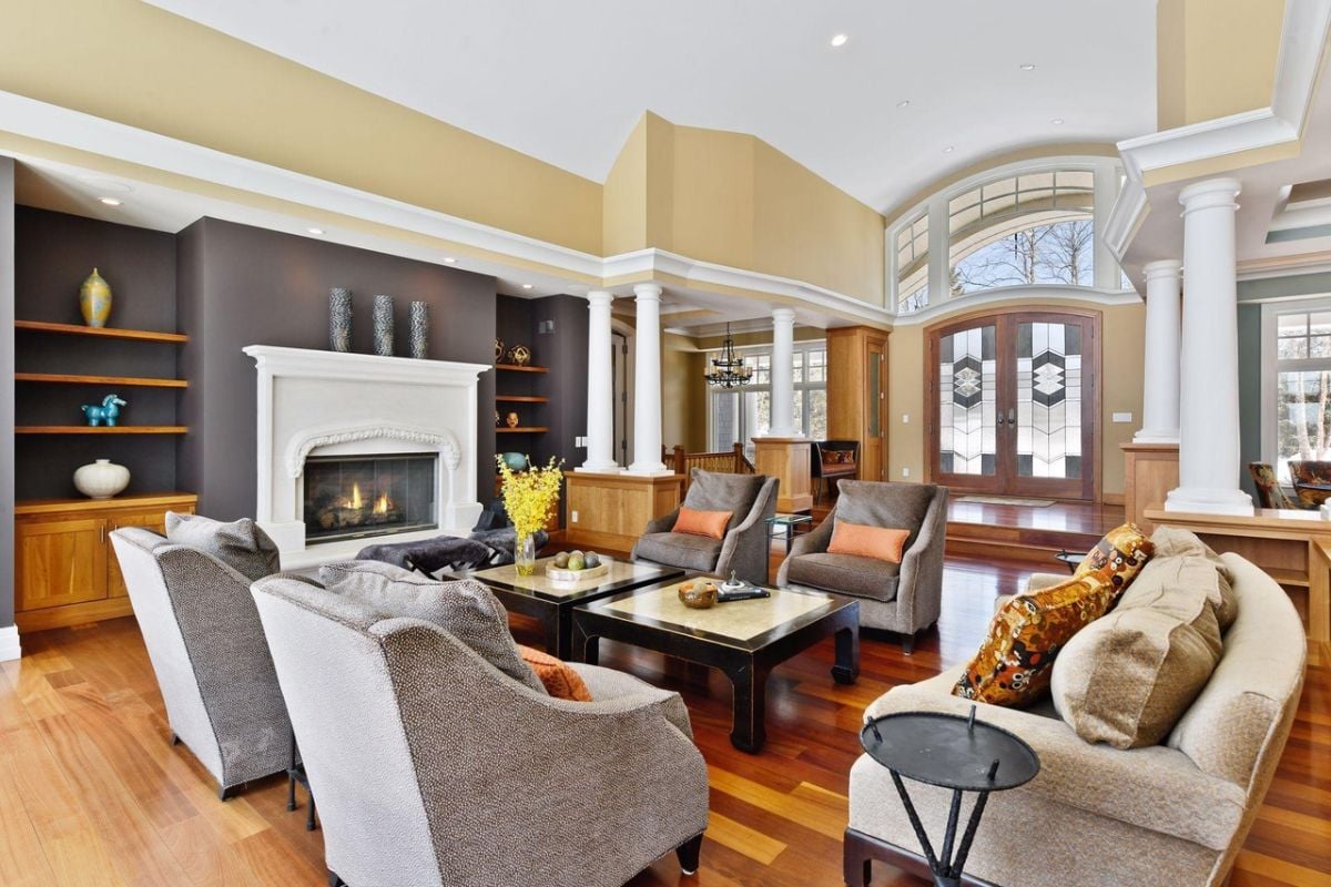 Living room with couches, a fireplace and wood flooring.