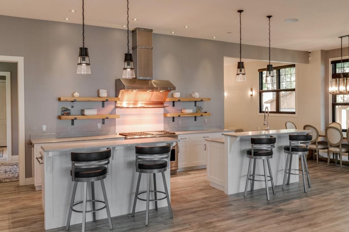 Kitchen with two kitchen center islands, custom lighting and custom cabinetry.