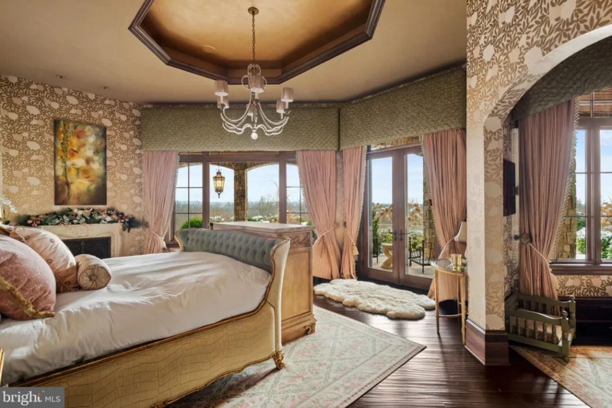 Bedroom with a chandelier, wood flooring, and glass doors.