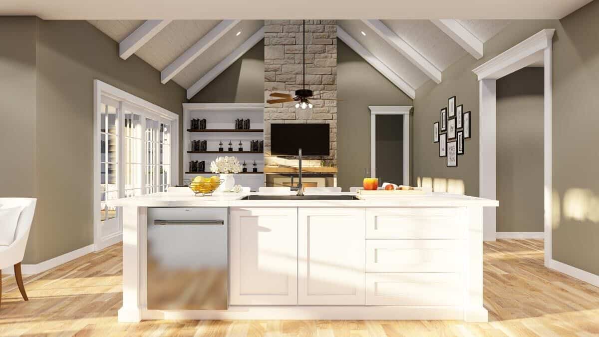 Kitchen island with a sink overlooking the vaulted great room.