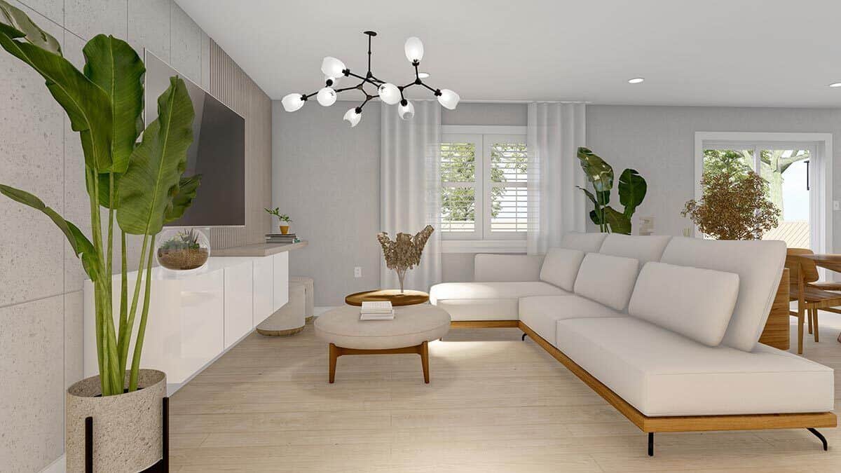 Family room with an L-shaped sectional and round coffee tables illuminated by a wrought iron chandelier.