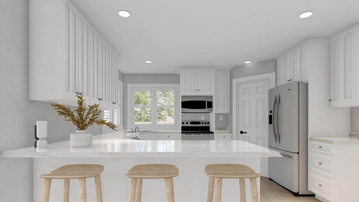Kitchen with white cabinetry, slate appliances, a corner pantry, and a peninsula bar with three seating.