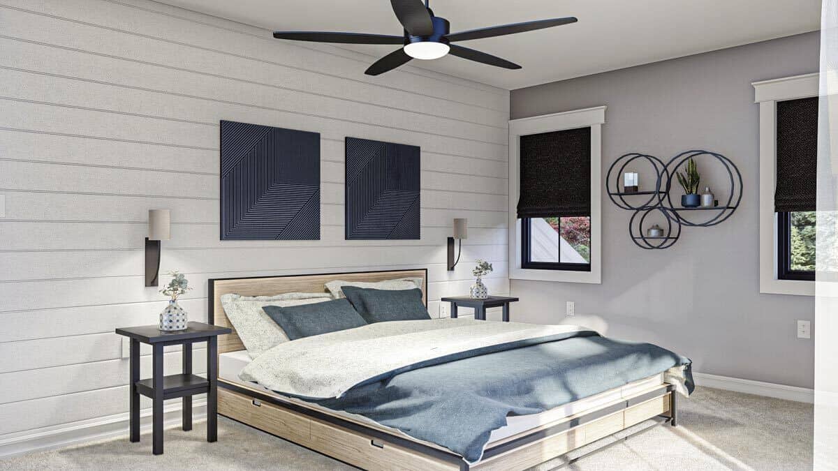 Secondary bedroom with a light wood bed and a shiplap accent wall adorned with minimalist artworks.