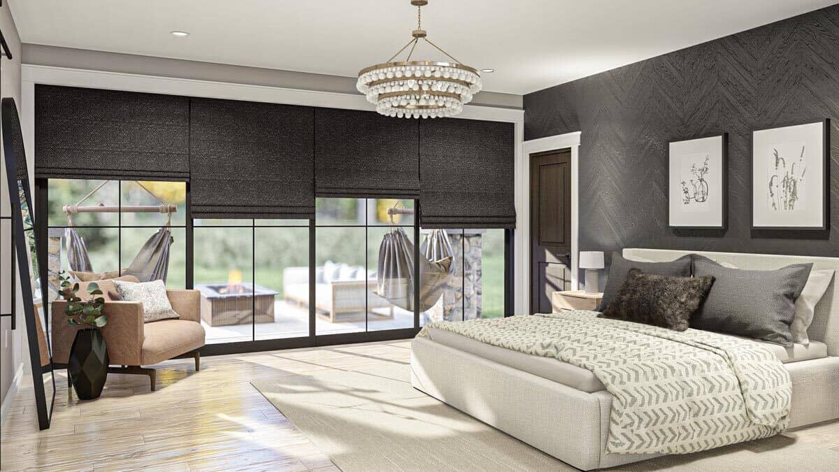 Primary bedroom with an upholstered bed, a beige armchair, and sliding glass doors that open to a covered patio.