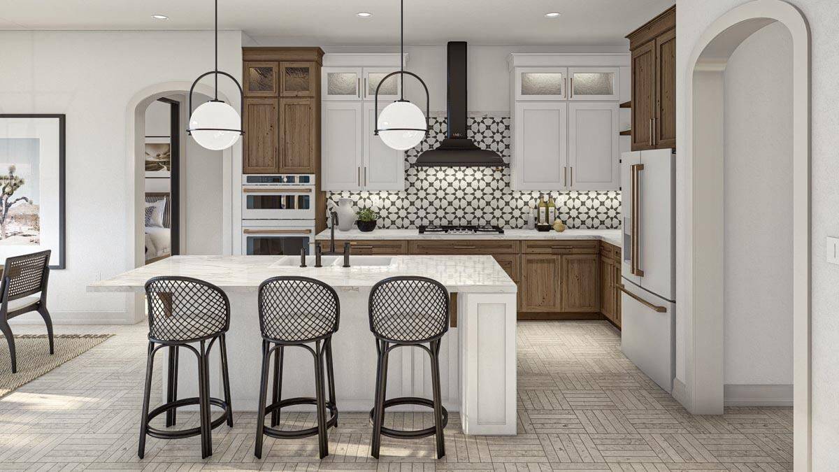 Kitchen with white and wooden cabinets, stainless steel appliances, and a breakfast island with three seating.