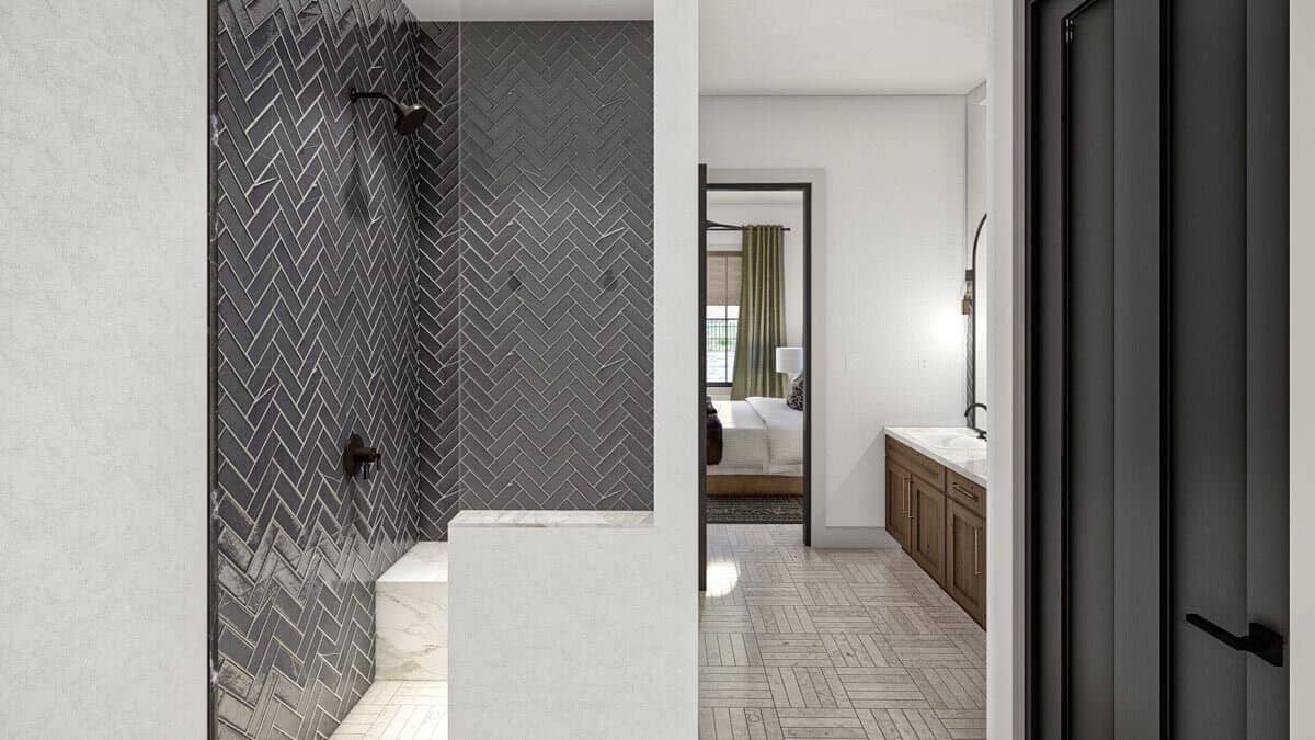 Primary bathroom with a walk-in shower equipped with wrought iron fixtures and a marble-tiled bench.