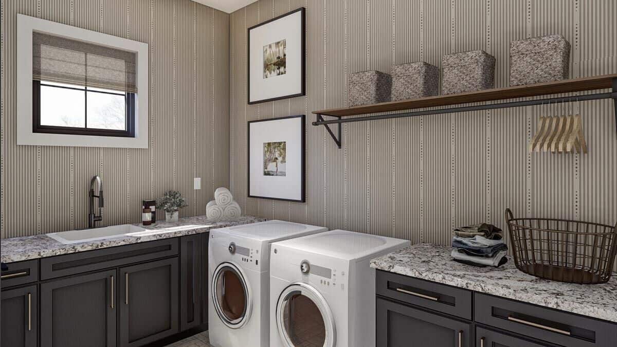 Laundry room with front-load washer and dryer, a sink, and granite countertops.