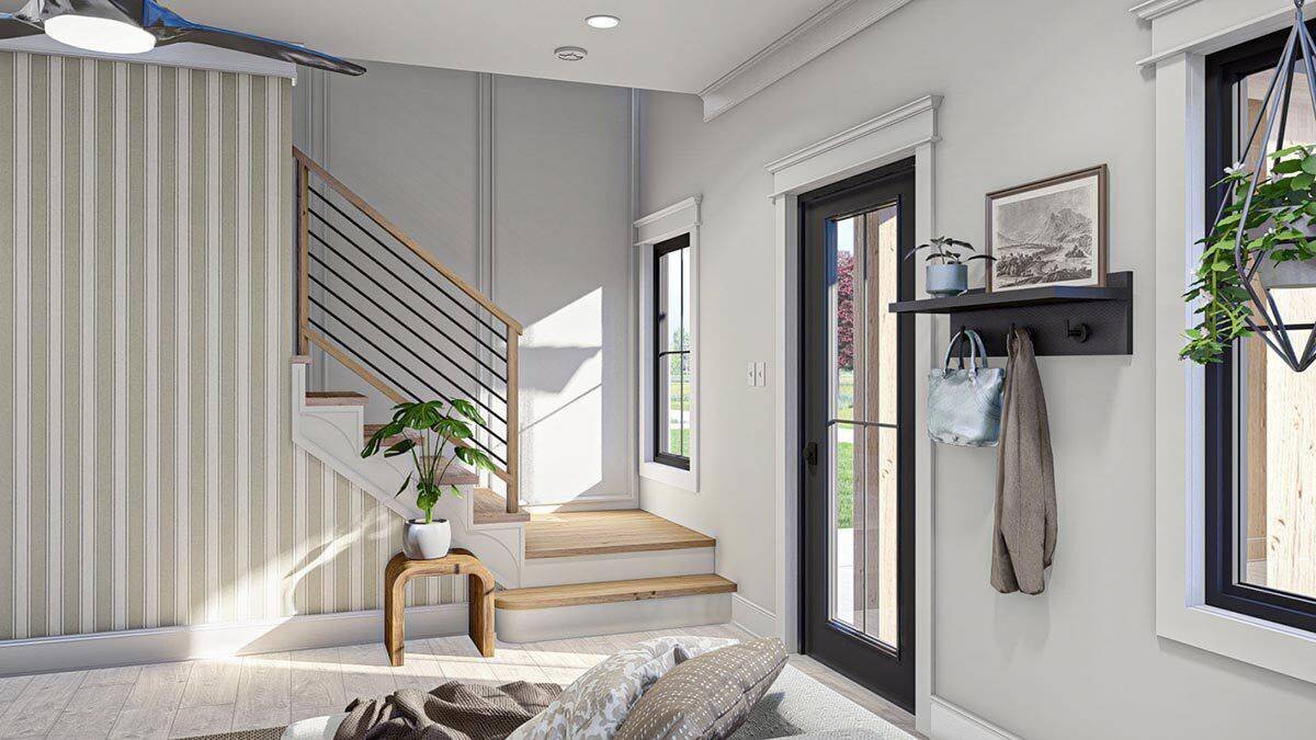 Entry hall with a glazed front door and a staircase leading to the sleeping quarters.