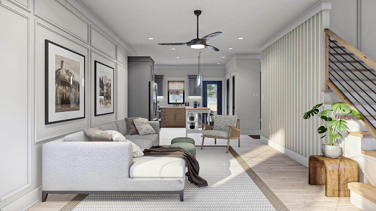 The living room includes hardwood flooring and a wainscoted wall adorned by framed artworks.