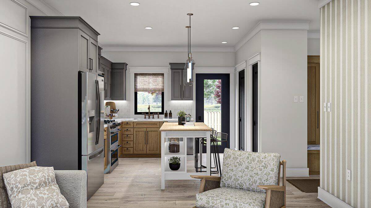 Kitchen with stainless steel appliances, custom cabinetry, and a center island illuminated by cylindrical pendants.