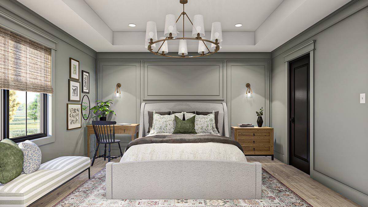 A tray ceiling mounted with a round chandelier crowns the primary bedroom.