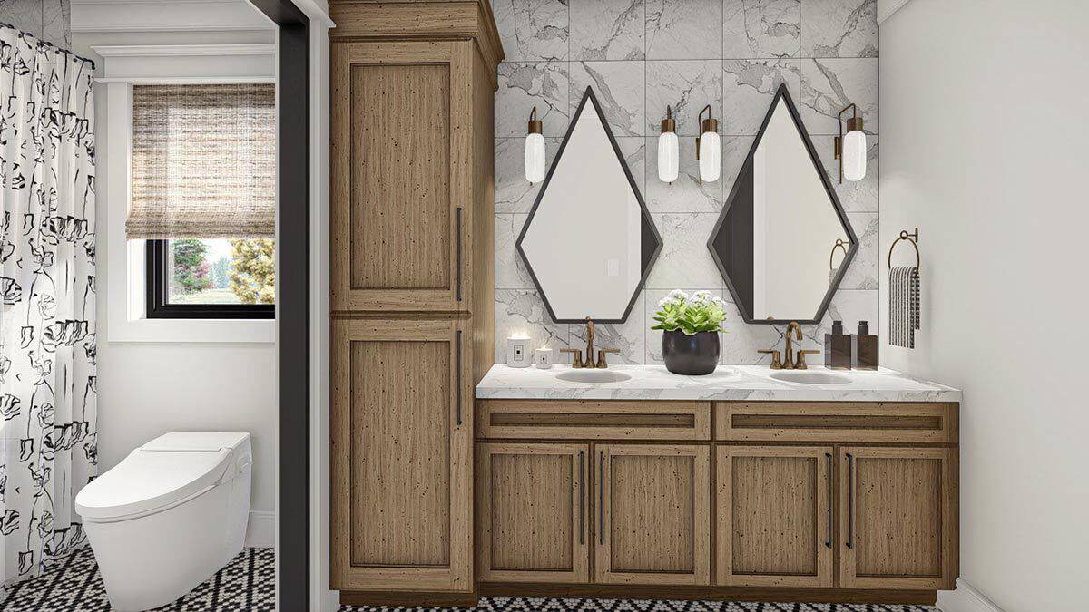 Shared bathroom with a dual sink vanity, a toilet, and a walk-in shower.
