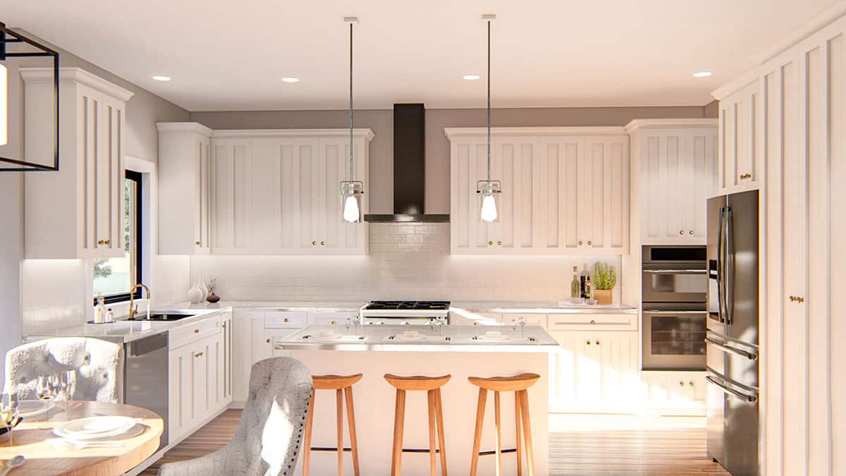 Kitchen with white cabinetry, stainless steel appliances, a center island, and an adjoining breakfast nook.