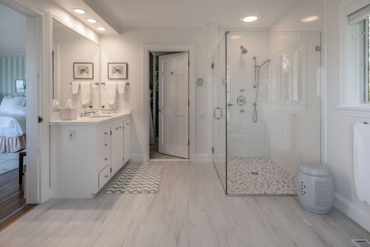 Bathroom with a sink, custom lighting, and a glass-enclosed shower.