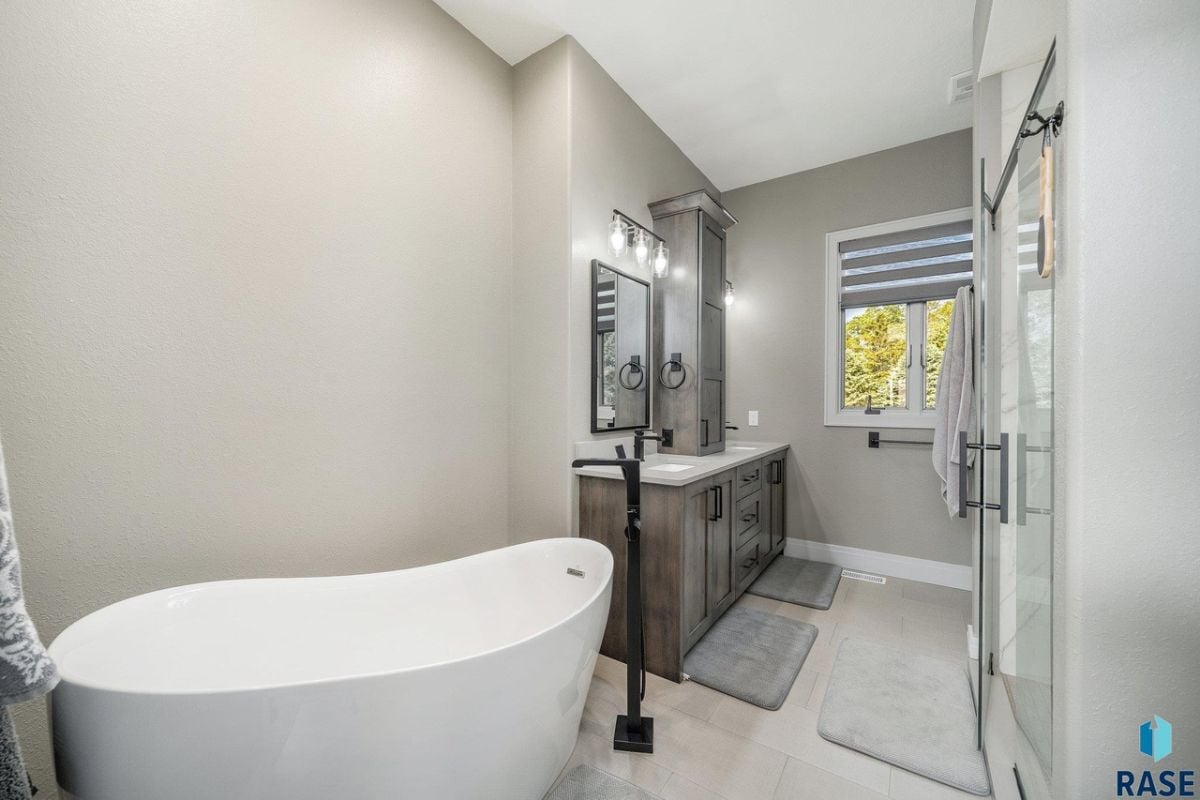 Bathroom with a sink, bath tub and a shower.