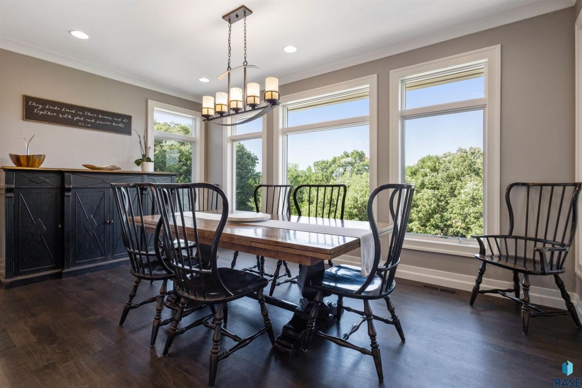 Dining room with wood floors and an amazing view from large glass windows.