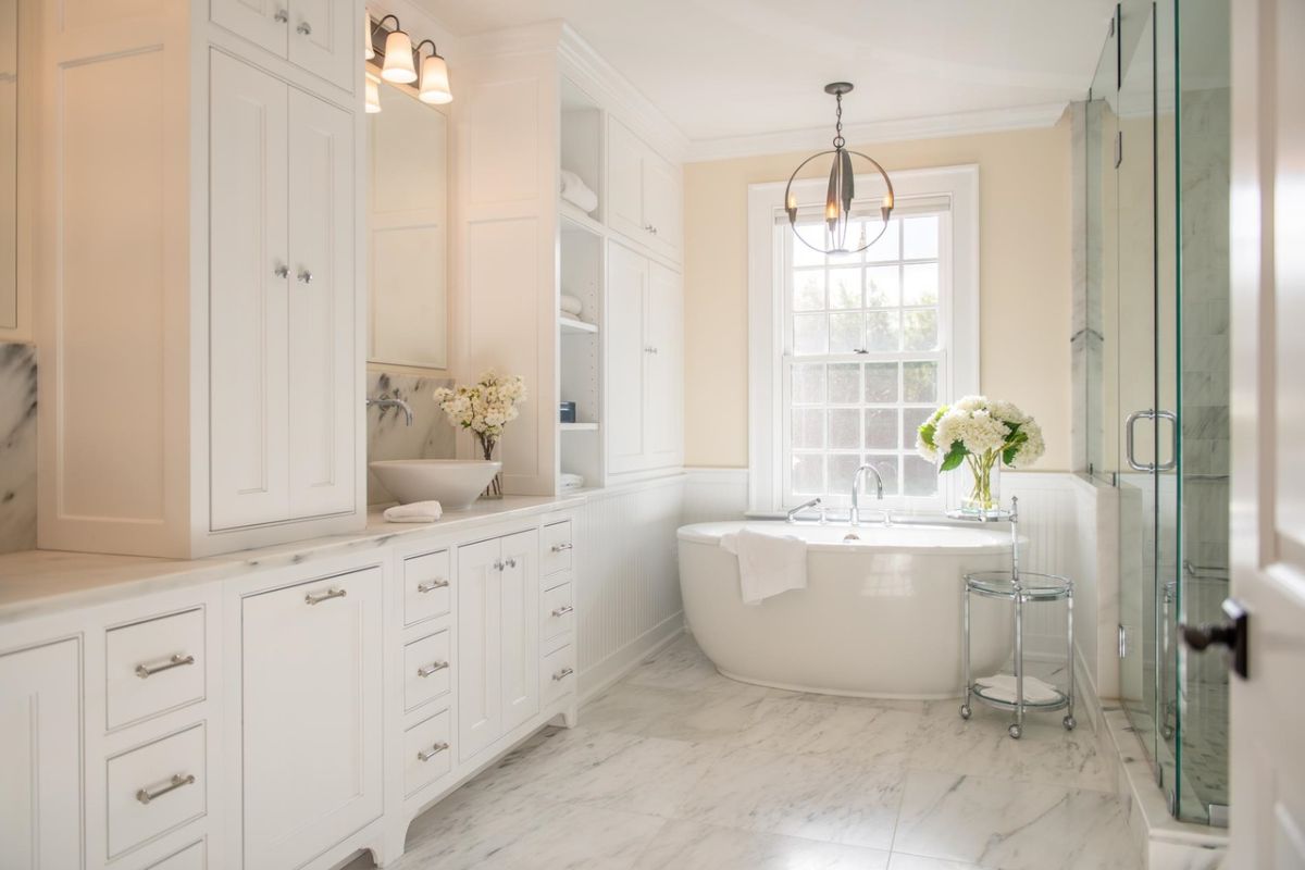 Bathroom with tile flooring, custom cabinetry, soaking tub and a shower.