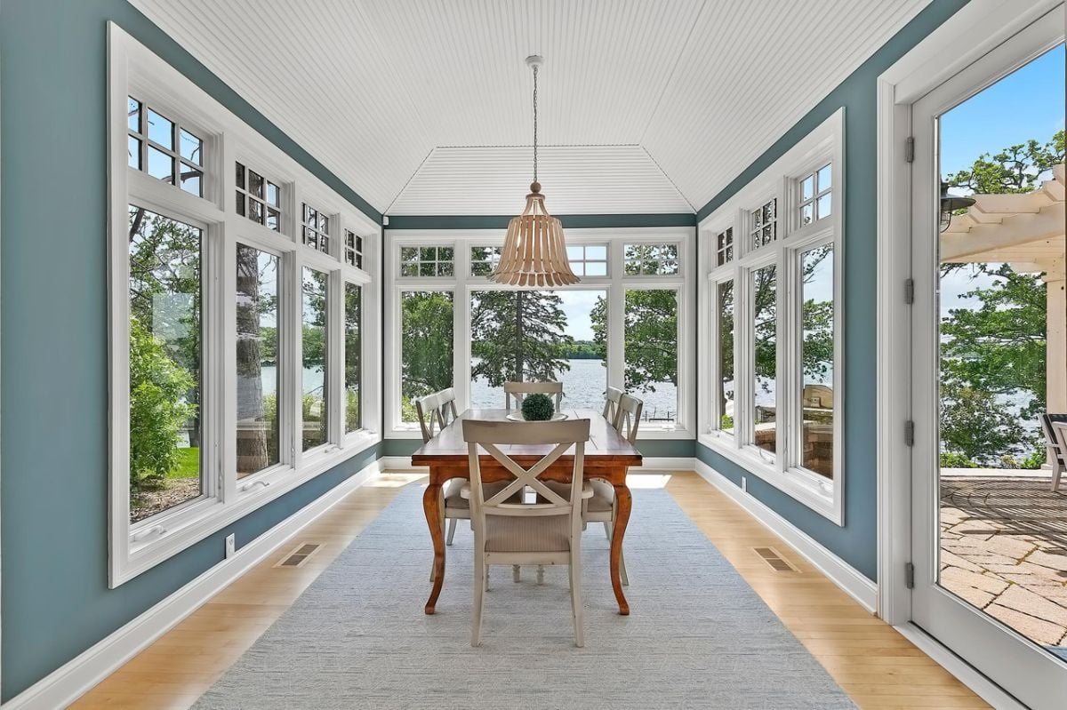 Breakfast area with glass windows and a view of the lake.