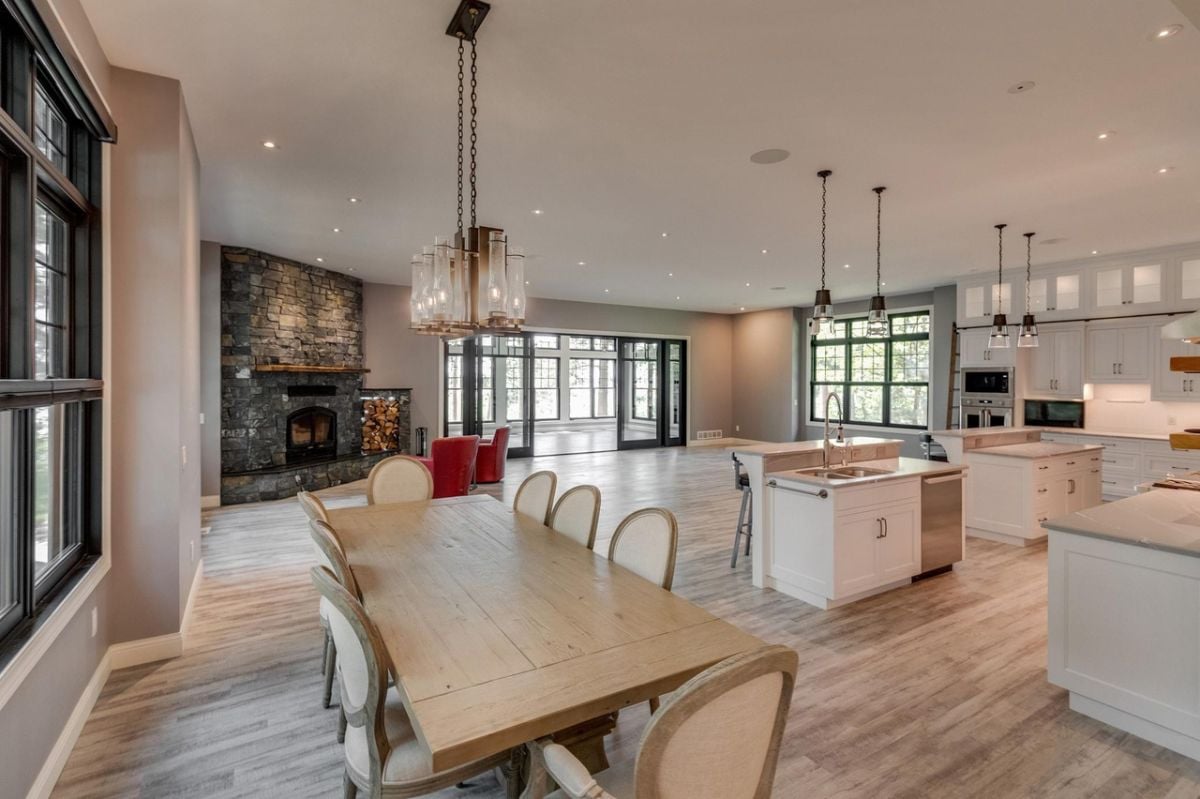 Dining room with a large wooden table and custom lighting.