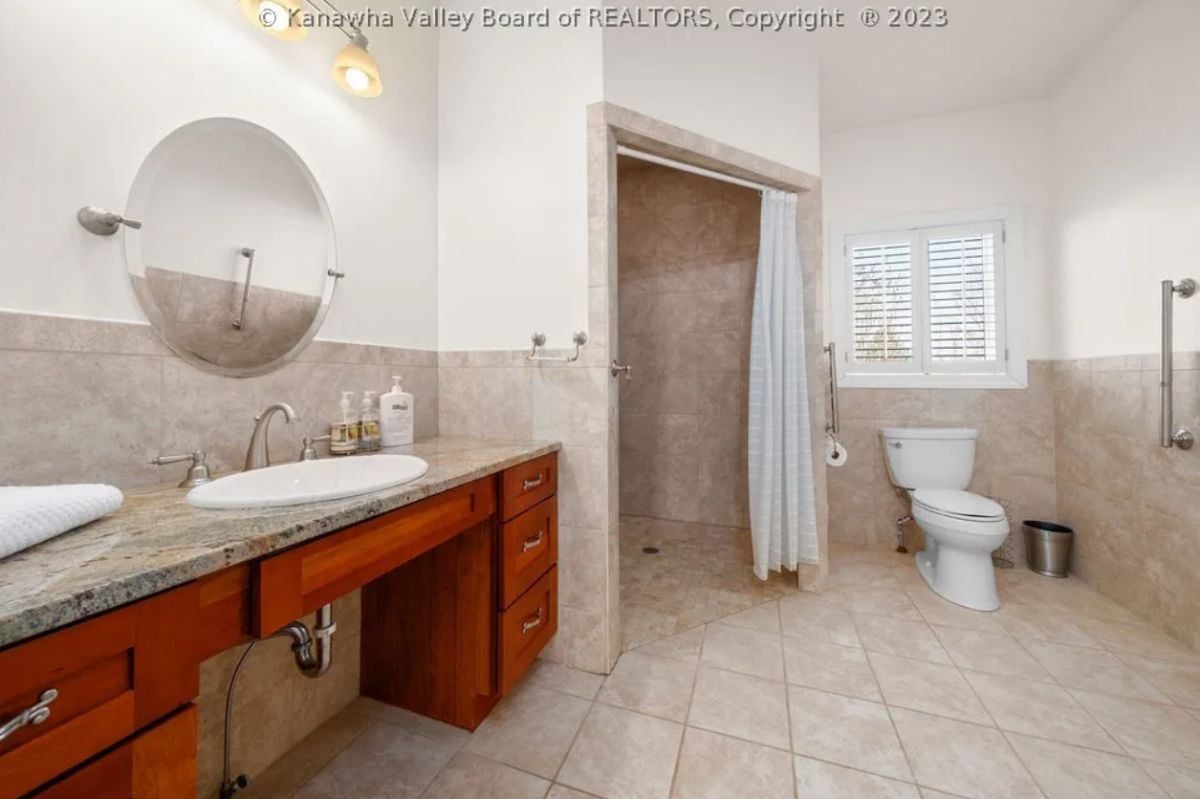 Bathroom with a sink, tile floors, shower, and a toilet.