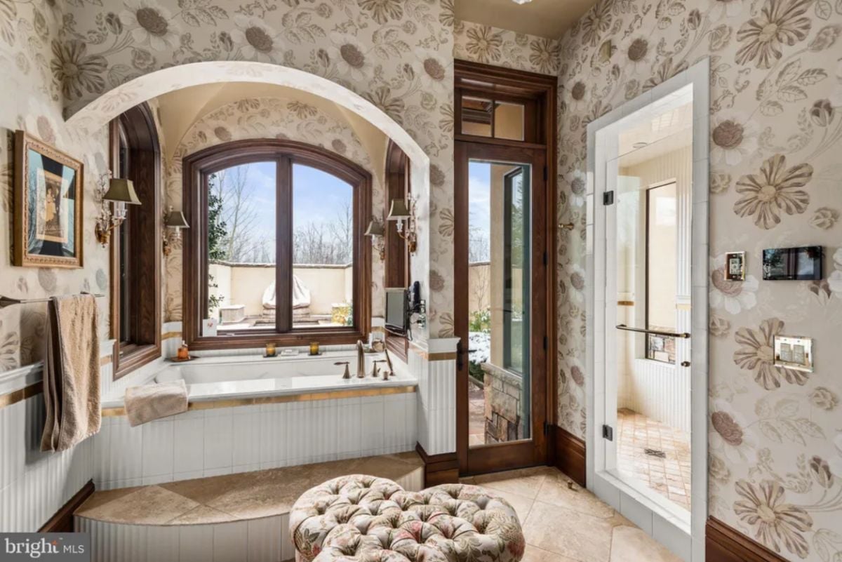 Bathroom with tile flooring, soaking tub and a shower.
