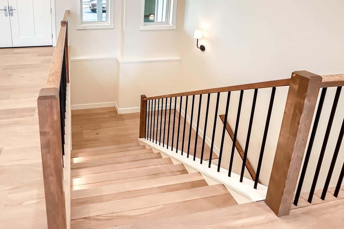 Stairs with wooden steps and wrought iron spindles.