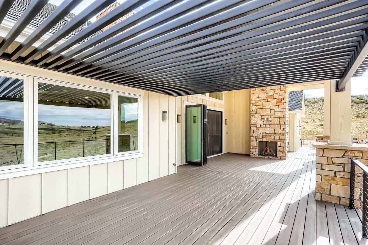 Rear deck with trellis porch and wide plank flooring.