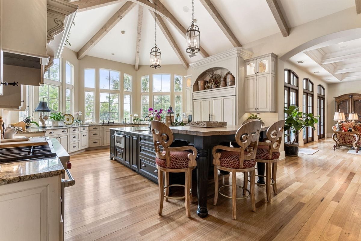 Kitchen with beamed ceilings, granite countertops, and custom cabinetry.
