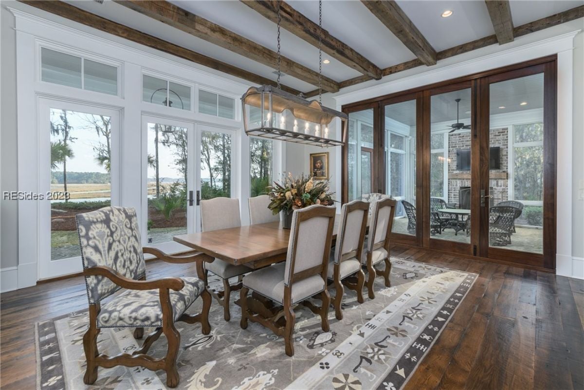 Dining room with large glass doors and a large table.