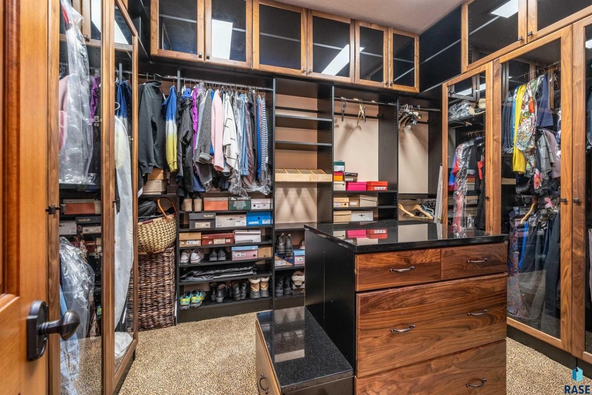 Walk-in closet with shelves and drawers.