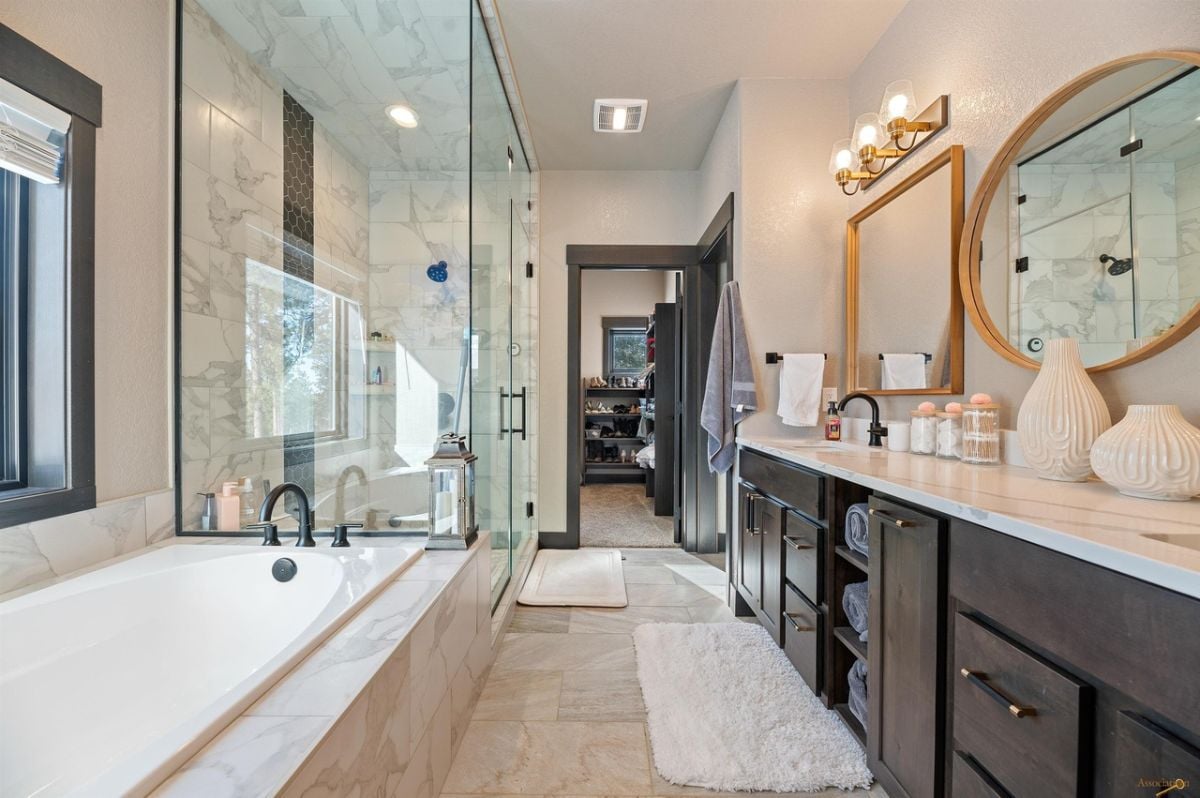 Bathroom with tile flooring, soaking tub and a shower.