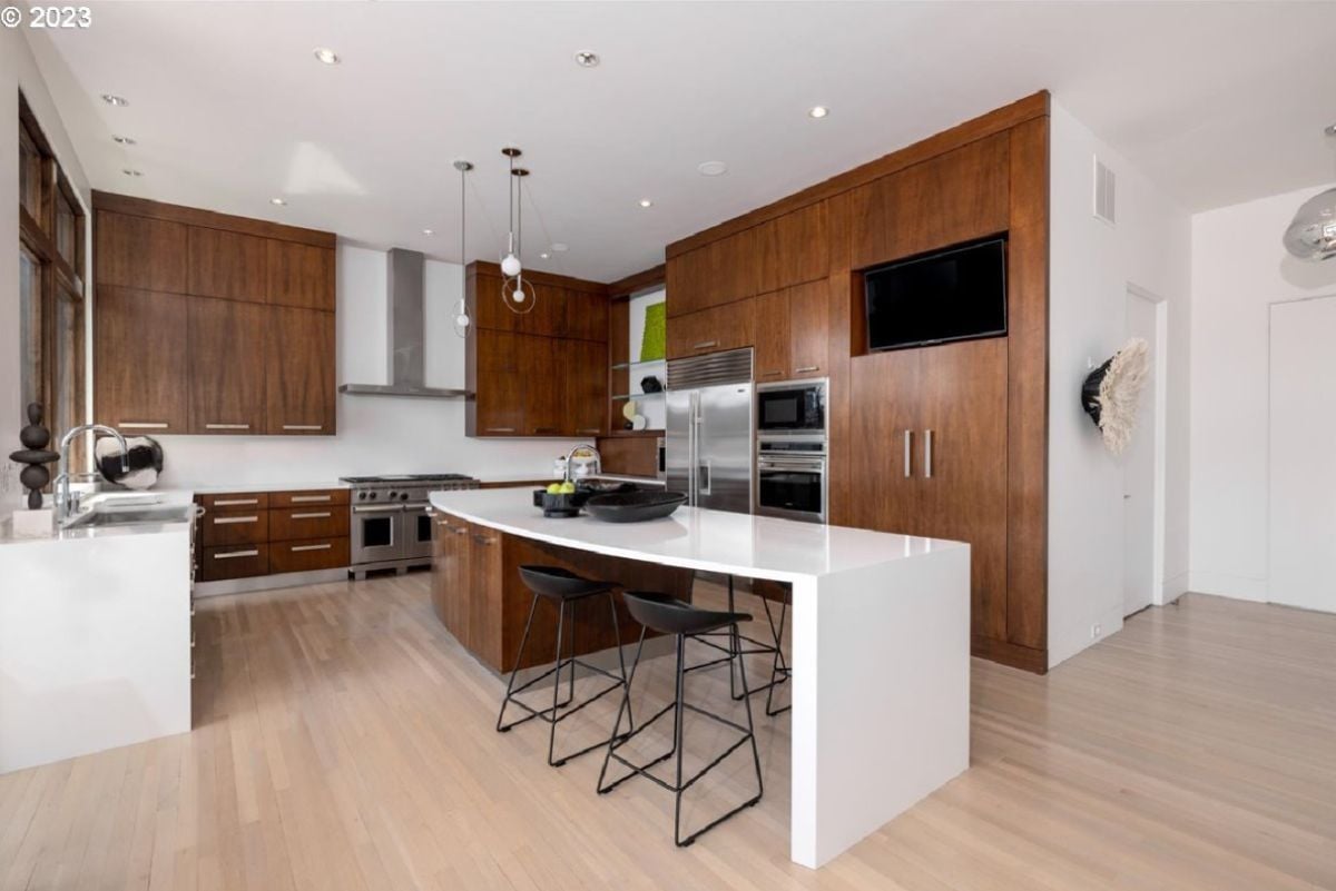 Kitchen with white countertops and wooden cabinets.