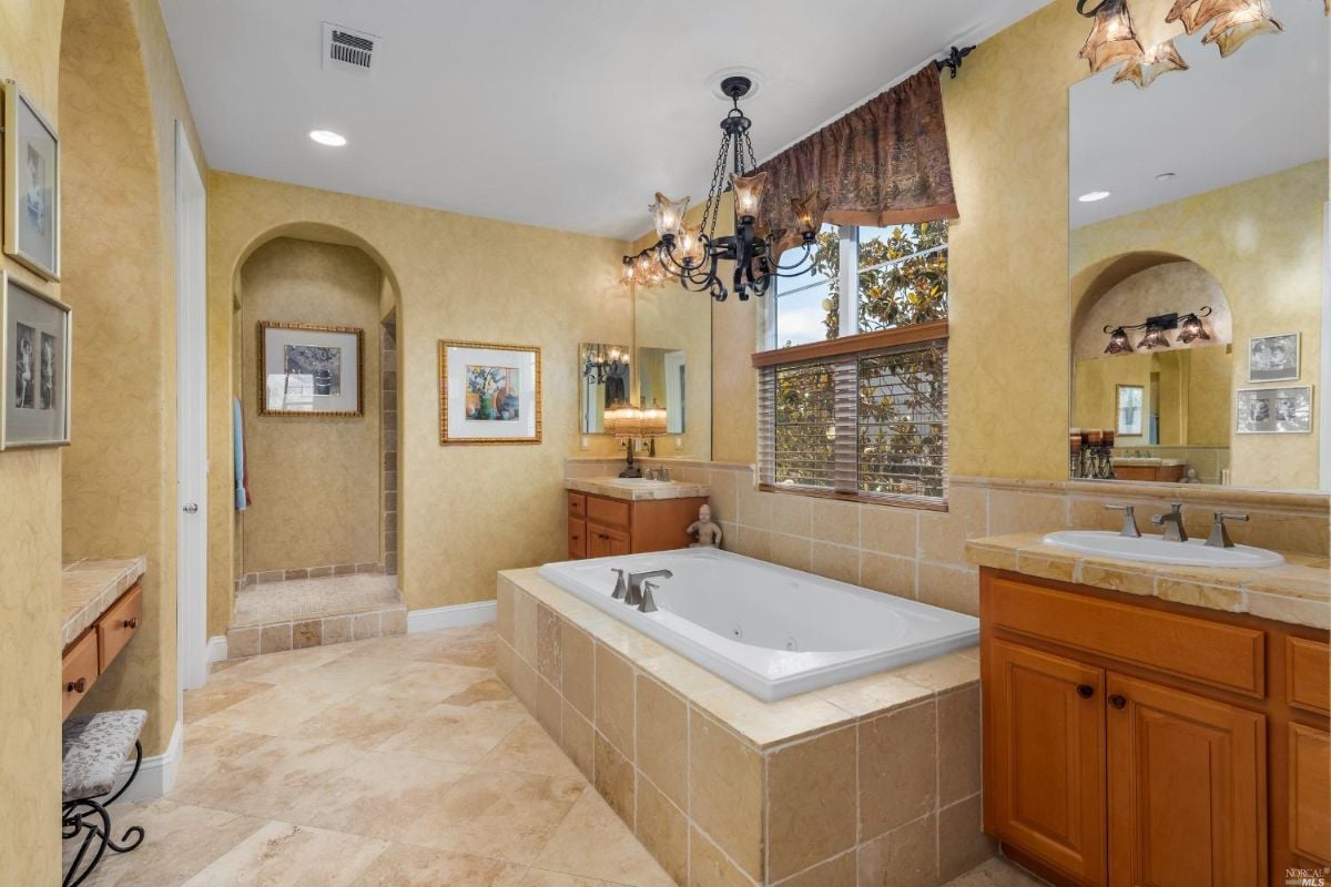 Bathroom with a sink, soaking tub, and drawers.